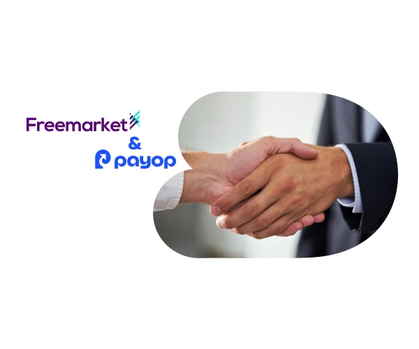 Two hands shaking in agreement next to Freemarket and Payop logos, symbolising a professional partnership.