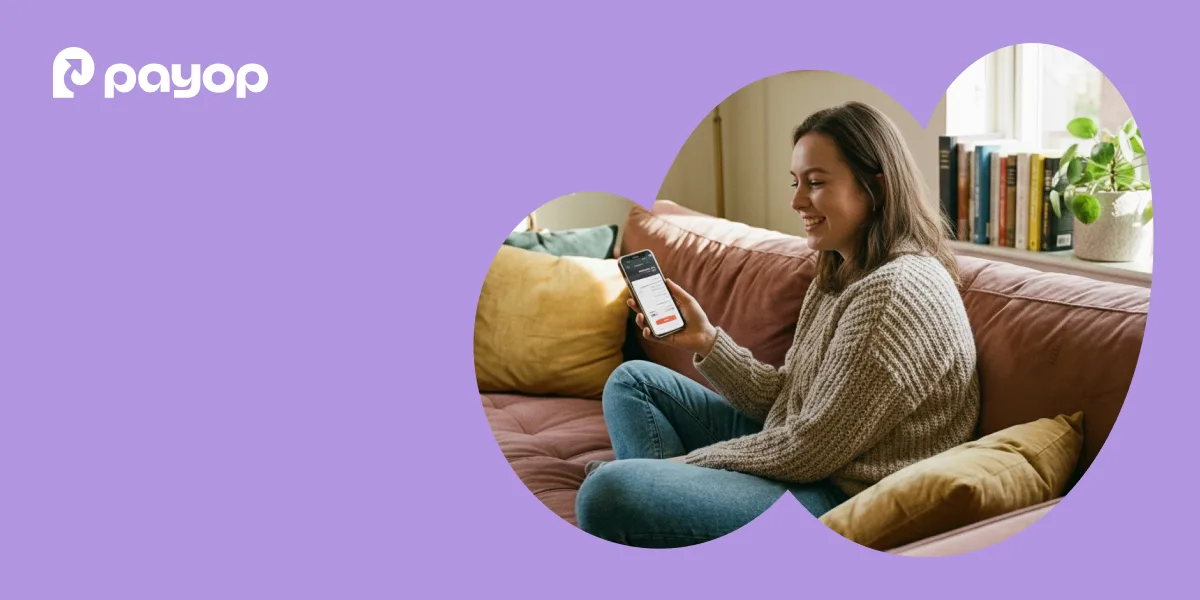 Purple background with the Payop logo in the top-left corner and a rounded cutout photo of a woman sitting on a sofa, smiling while looking at a smartphone in her hand